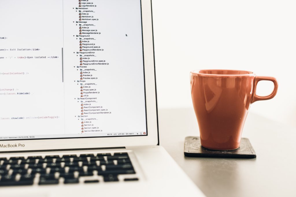 coding screen with mug